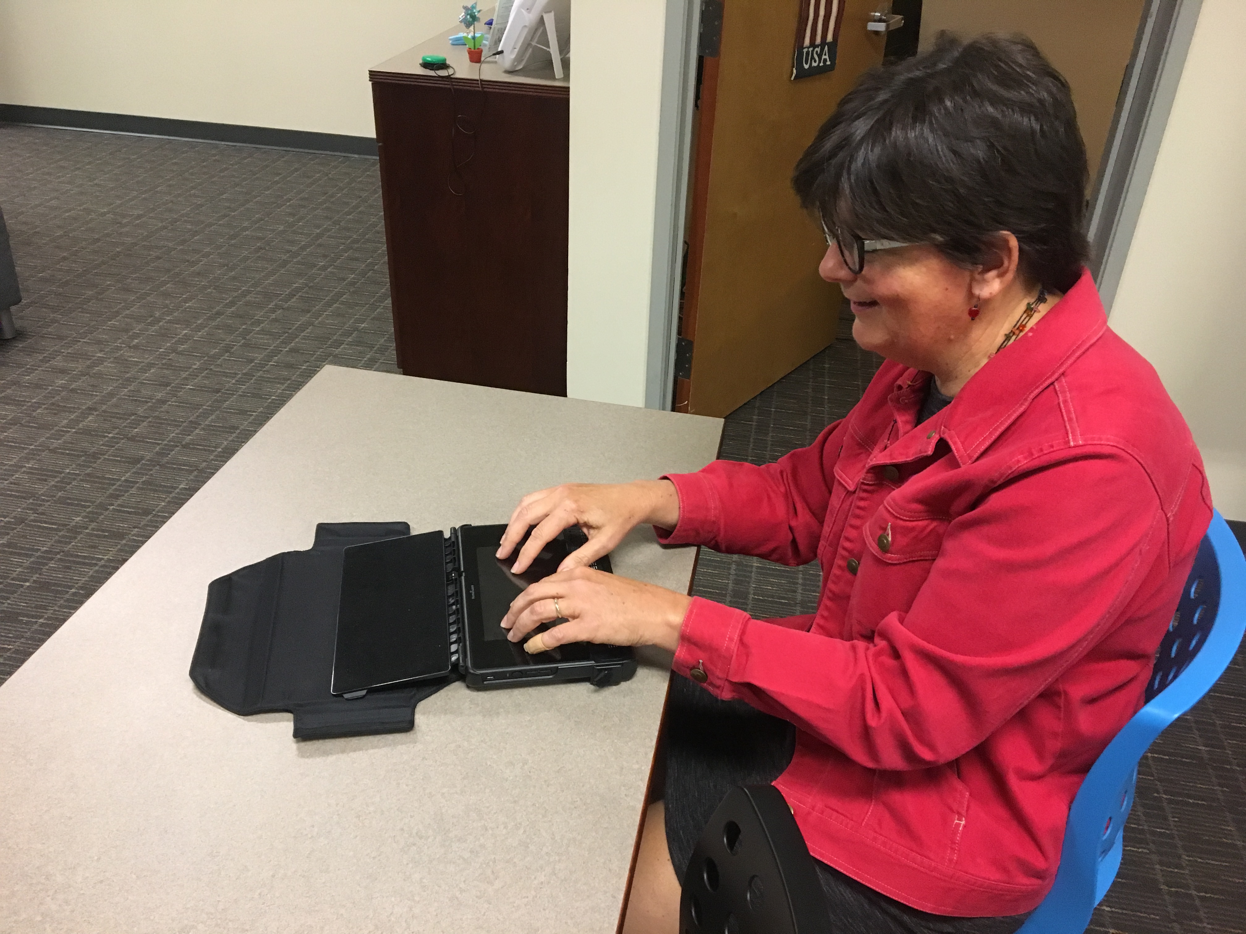 Bev Sharritt using a Braille Note Touch