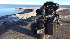 Dirty Motorcycle at the edge of the water and land at the Bonneville Salt Flats