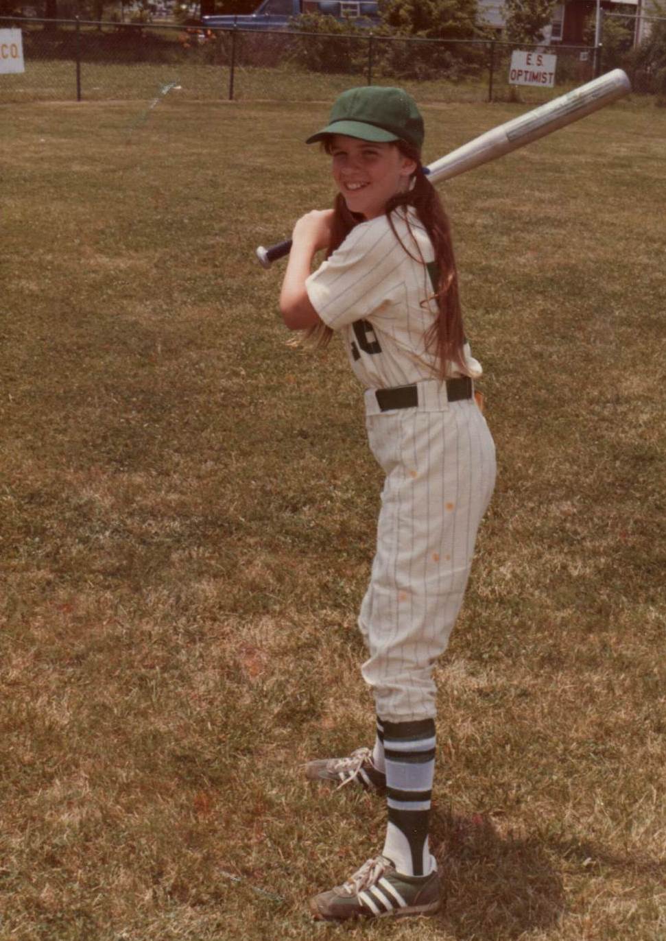 Sandy as a young girl in her baseball uniform.