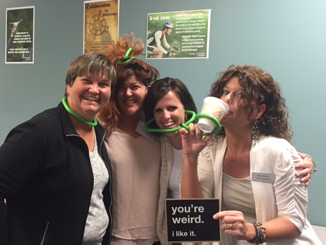Gloria Crowell, Rachel Herron, Shellie Parr, and Kelli Suding being silly with a sign worded you're weird. I like it.